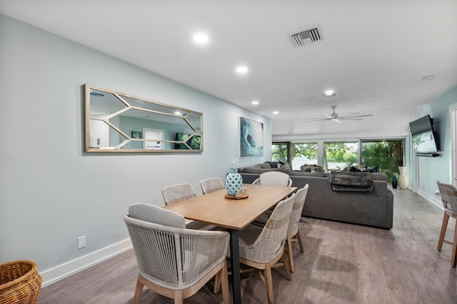 dining space with ceiling fan and wood-type flooring