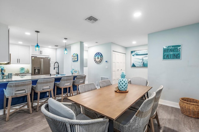 dining area with sink and hardwood / wood-style floors