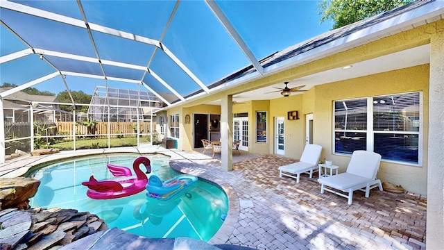 view of pool featuring a lanai, ceiling fan, and a patio area