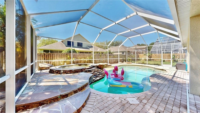 view of pool featuring an in ground hot tub, a lanai, and a patio