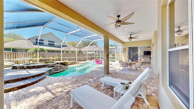 view of pool featuring a patio, ceiling fan, and glass enclosure