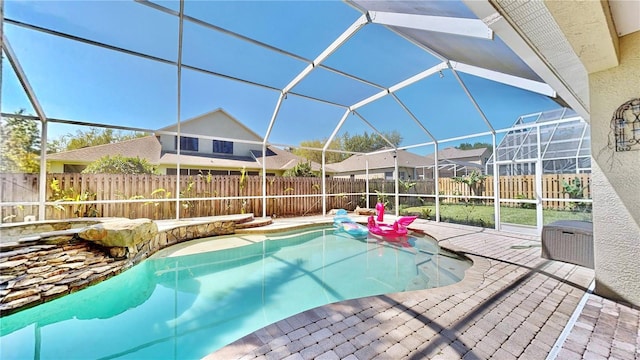 view of swimming pool with a lanai and a patio area