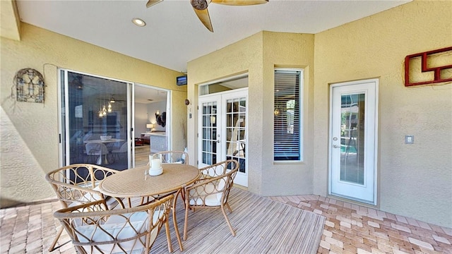 sunroom featuring french doors and ceiling fan