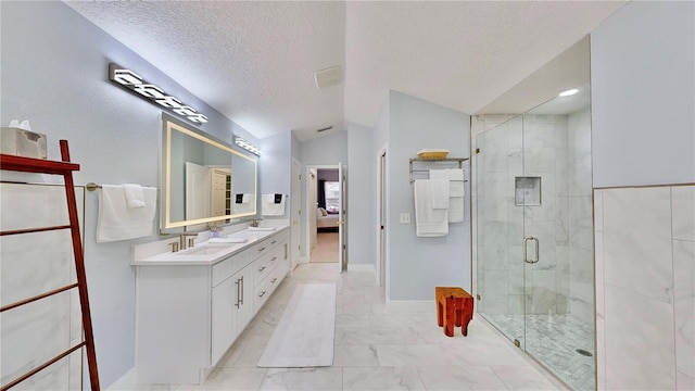 bathroom with walk in shower, vanity, vaulted ceiling, and a textured ceiling