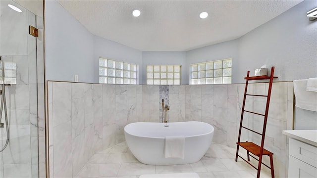 bathroom with plenty of natural light, shower with separate bathtub, and a textured ceiling