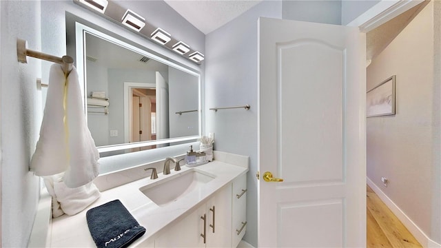 bathroom featuring hardwood / wood-style flooring and vanity