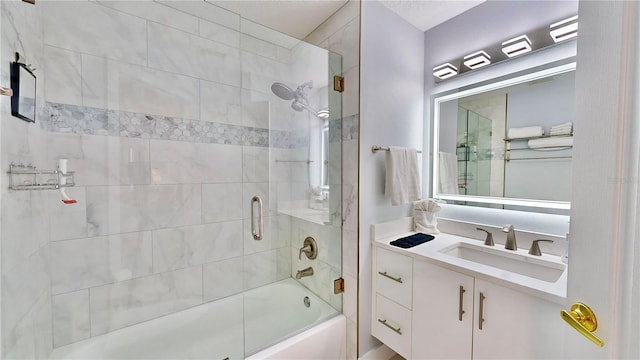 bathroom featuring vanity and shower / bath combination with glass door