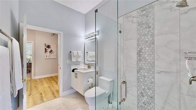 bathroom with vanity, an enclosed shower, hardwood / wood-style flooring, and toilet