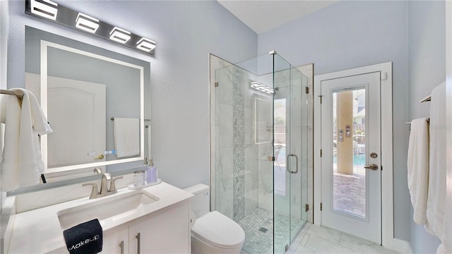 bathroom featuring walk in shower, vanity, and toilet