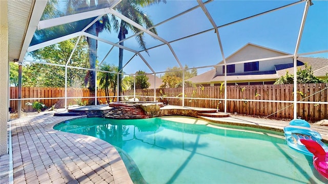 view of pool with an in ground hot tub, a lanai, and a patio