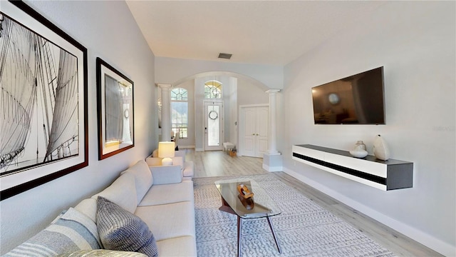 living room featuring ornate columns and light hardwood / wood-style floors