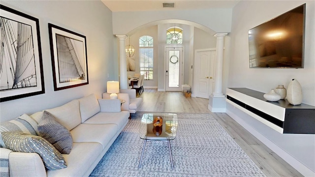 living room featuring ornate columns and light hardwood / wood-style flooring