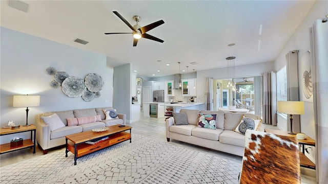 living room with ceiling fan and light hardwood / wood-style floors