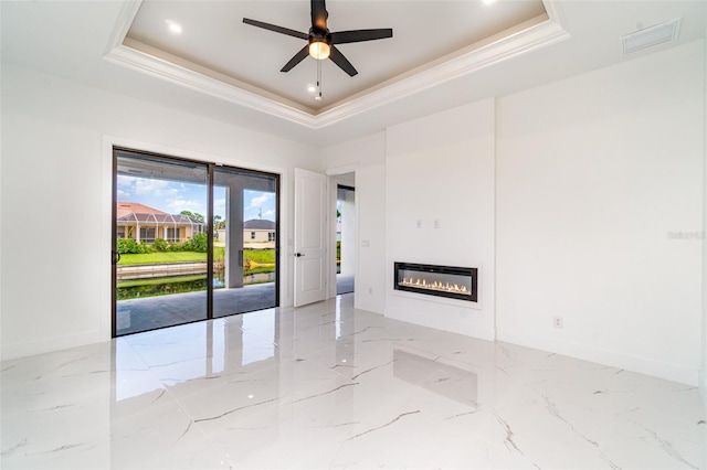 unfurnished room featuring light tile patterned floors, ceiling fan, and a tray ceiling