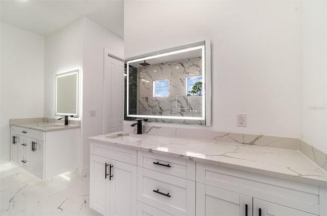 full bath with marble finish floor, vanity, and a marble finish shower