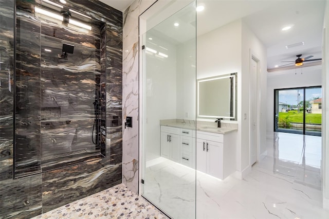 bathroom with marble finish floor, a marble finish shower, vanity, and recessed lighting