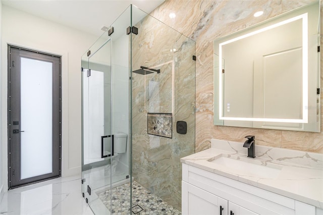 bathroom featuring tasteful backsplash, a shower stall, and vanity