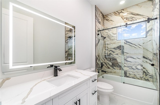 full bathroom with vanity, tiled shower / bath combo, and toilet