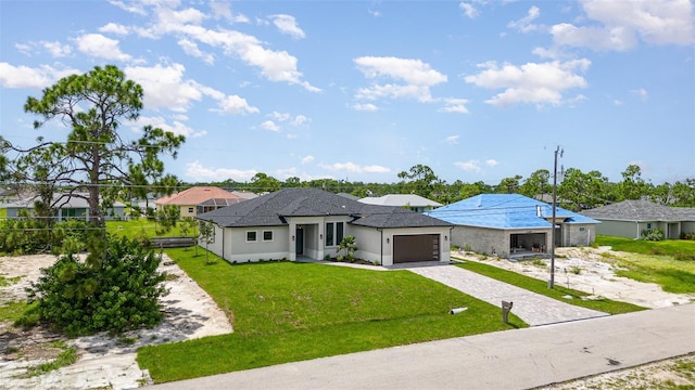 view of front of house with a garage, decorative driveway, and a front yard