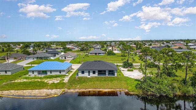 bird's eye view featuring a water view and a residential view