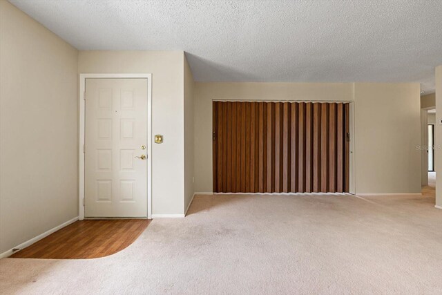 empty room featuring light hardwood / wood-style floors and a textured ceiling