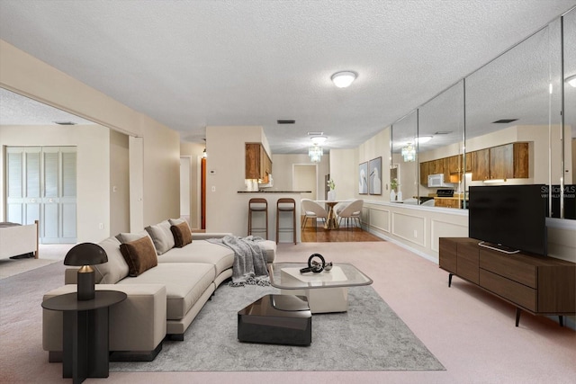 carpeted living room with a textured ceiling