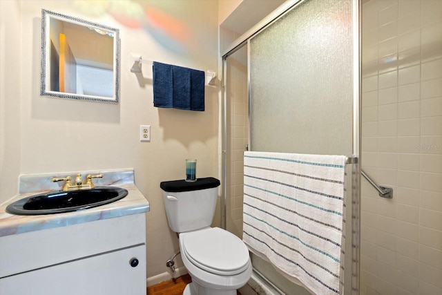 bathroom featuring vanity, hardwood / wood-style flooring, and toilet