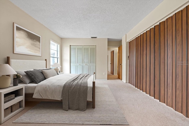 carpeted bedroom featuring a closet and a textured ceiling