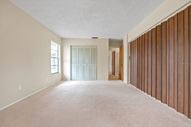 unfurnished bedroom with carpet flooring and a textured ceiling