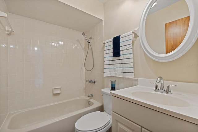 full bathroom with vanity, tiled shower / bath, and toilet