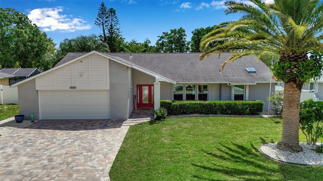 single story home with a garage and a front lawn