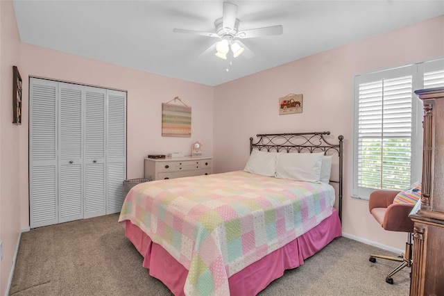 bedroom featuring light colored carpet, a closet, and ceiling fan