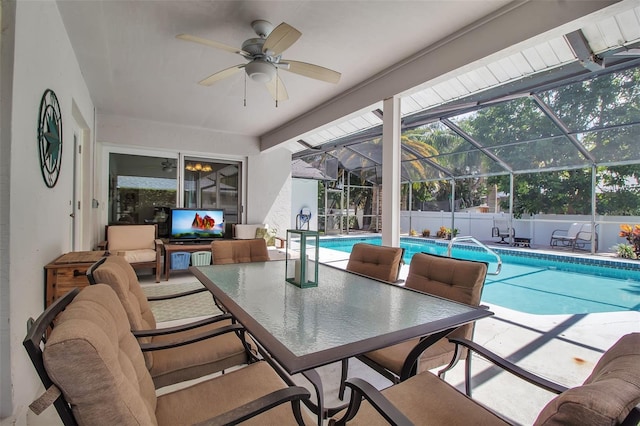 exterior space featuring a patio area, exterior kitchen, ceiling fan, and glass enclosure