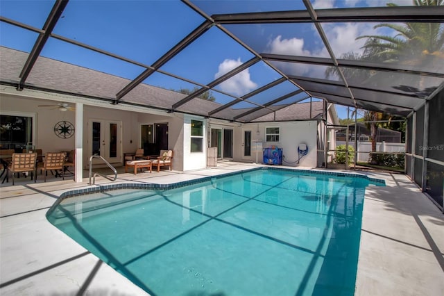 view of pool featuring french doors, a patio area, glass enclosure, outdoor lounge area, and ceiling fan