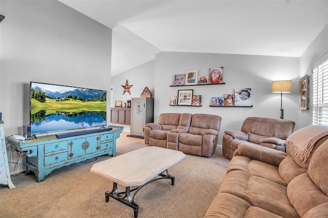 carpeted living room with vaulted ceiling