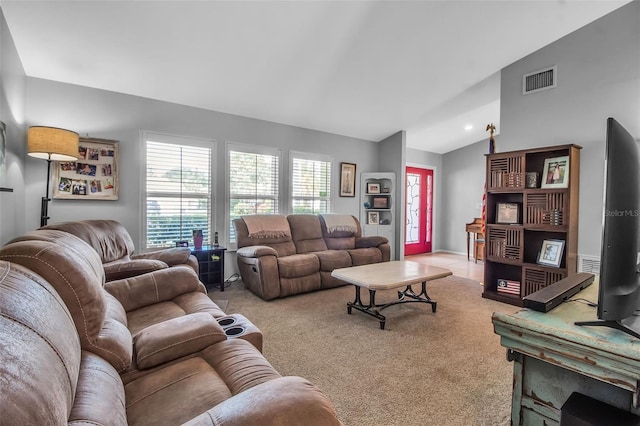 carpeted living room with lofted ceiling