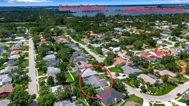 drone / aerial view featuring a residential view and a water view