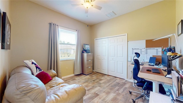 home office featuring ceiling fan and light hardwood / wood-style flooring