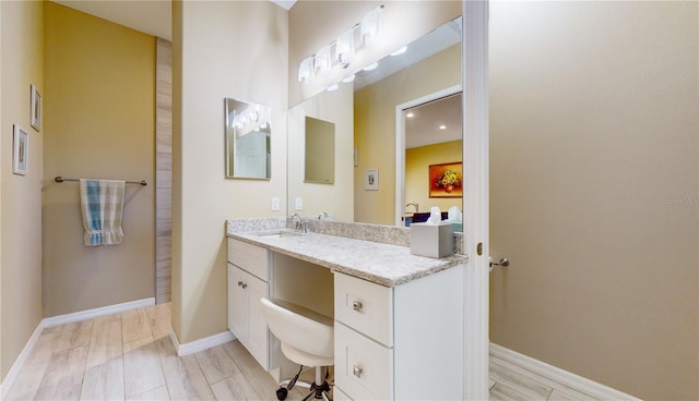 bathroom with vanity and wood-type flooring