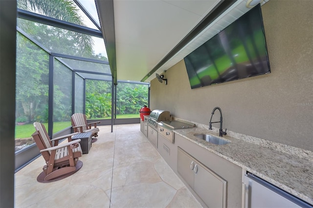 view of patio / terrace with an outdoor kitchen, area for grilling, a lanai, and sink