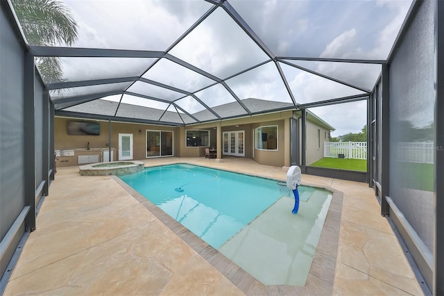 view of pool with glass enclosure, a patio area, an in ground hot tub, and french doors