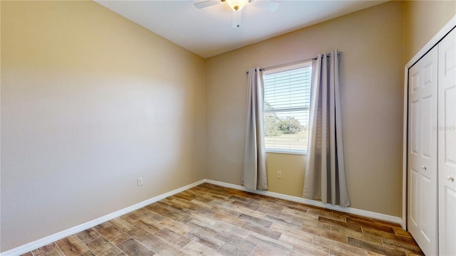 unfurnished room with ceiling fan and light wood-type flooring