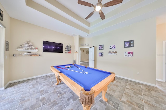 playroom featuring a tray ceiling, ceiling fan, and pool table