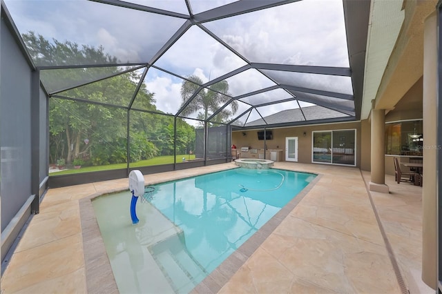 view of swimming pool with glass enclosure, an in ground hot tub, and a patio