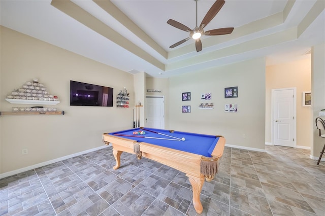 recreation room featuring a tray ceiling, baseboards, stone finish flooring, ceiling fan, and pool table