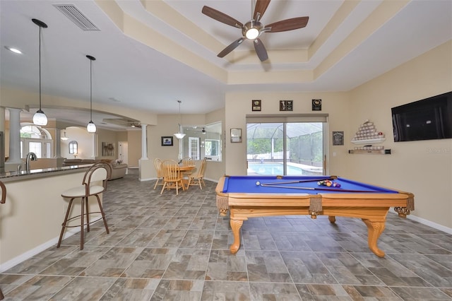 game room featuring billiards, ceiling fan, a tray ceiling, visible vents, and decorative columns