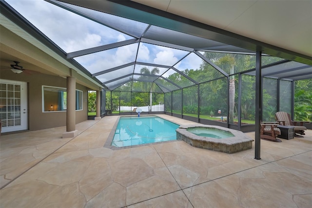 view of pool with a patio area, a lanai, ceiling fan, and a pool with connected hot tub