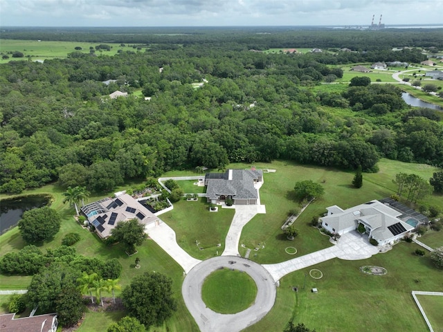 aerial view featuring a wooded view and a water view