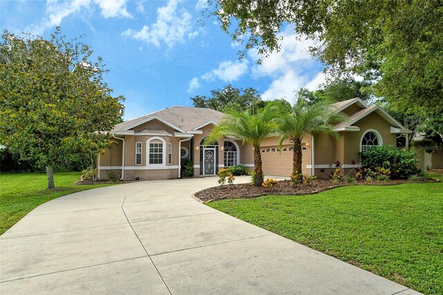 single story home with a garage and a front yard