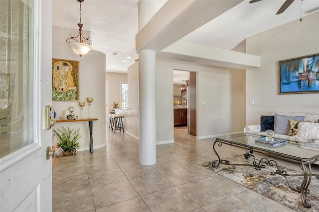 interior space featuring ceiling fan and light tile patterned floors